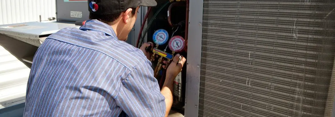 HVAC technician servicing a condenser unit in Santa Clara