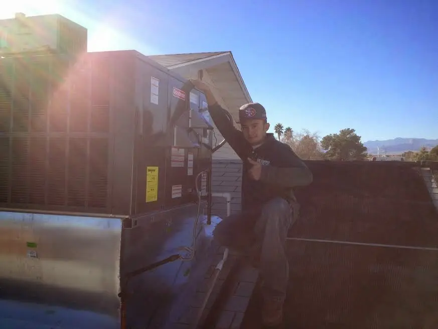 HVAC technician performing Boiler Repair on a rooftop unit in Santa Clara
